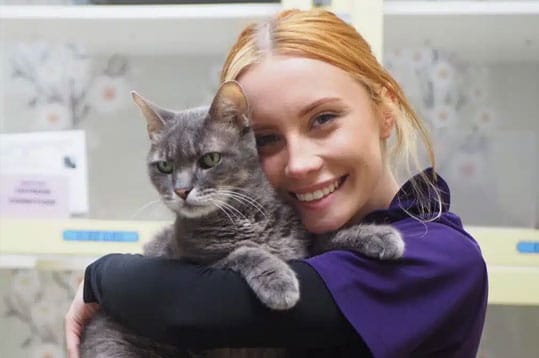 woman hugging a cat