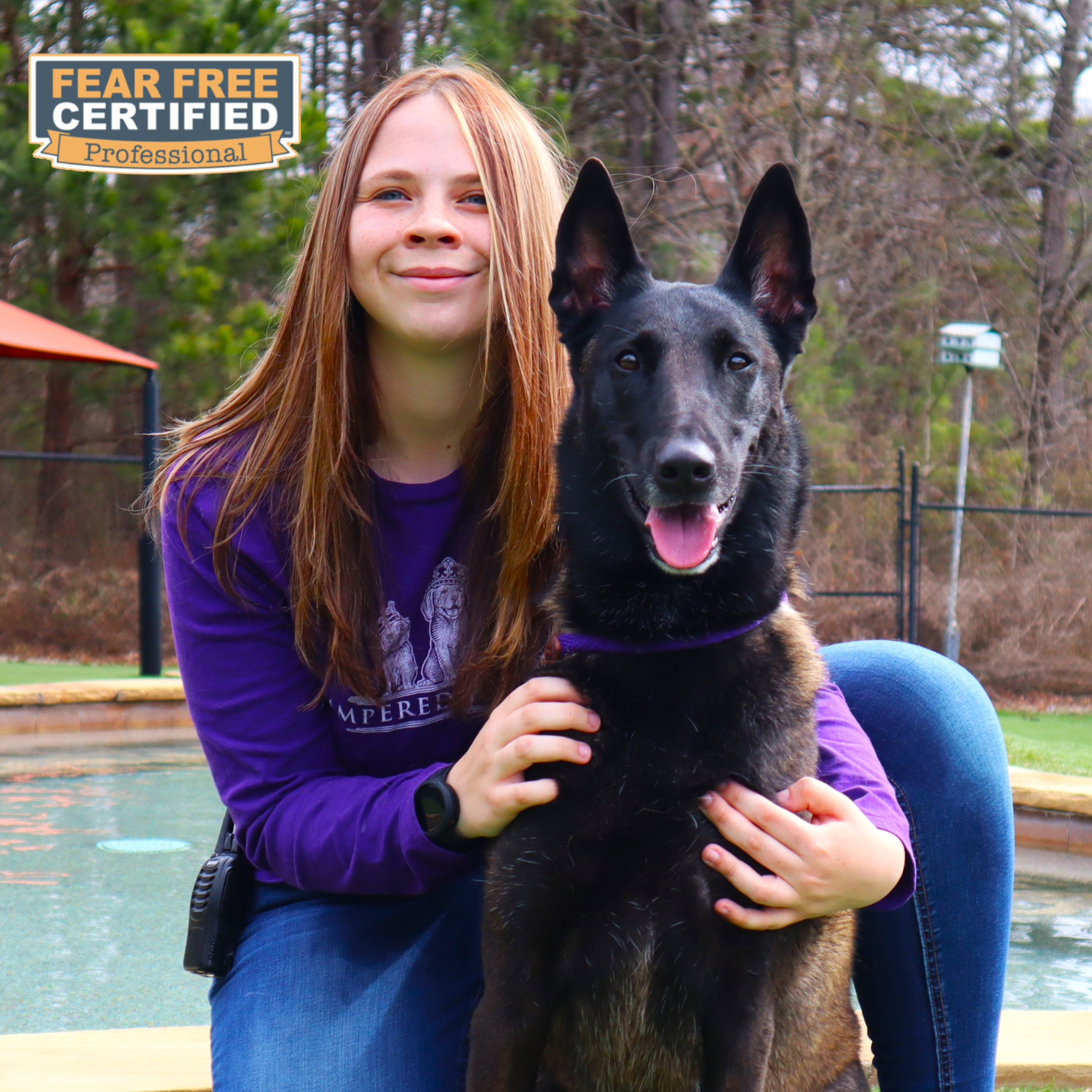 Staff member posing with dog guest