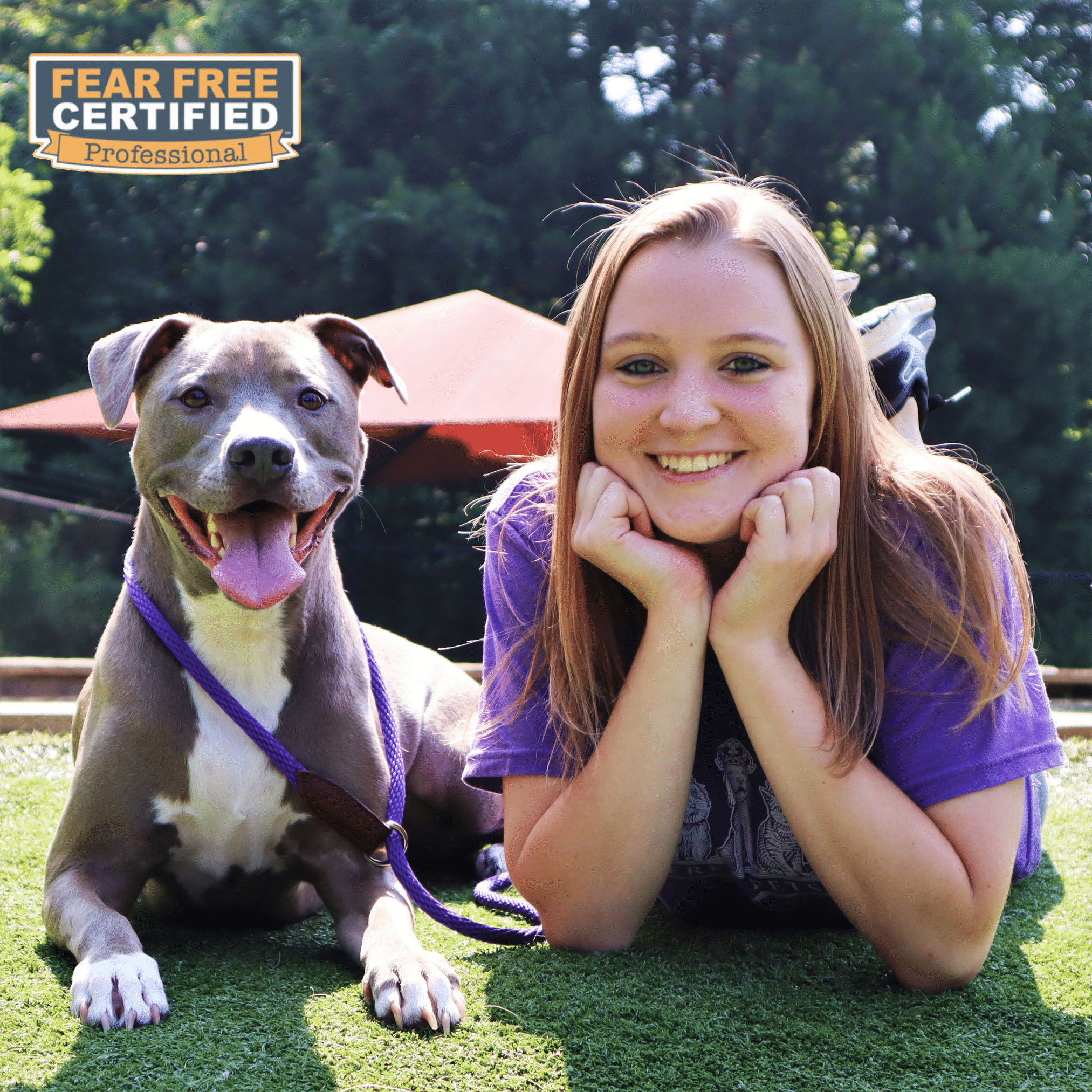 Staff member posing with dog guest