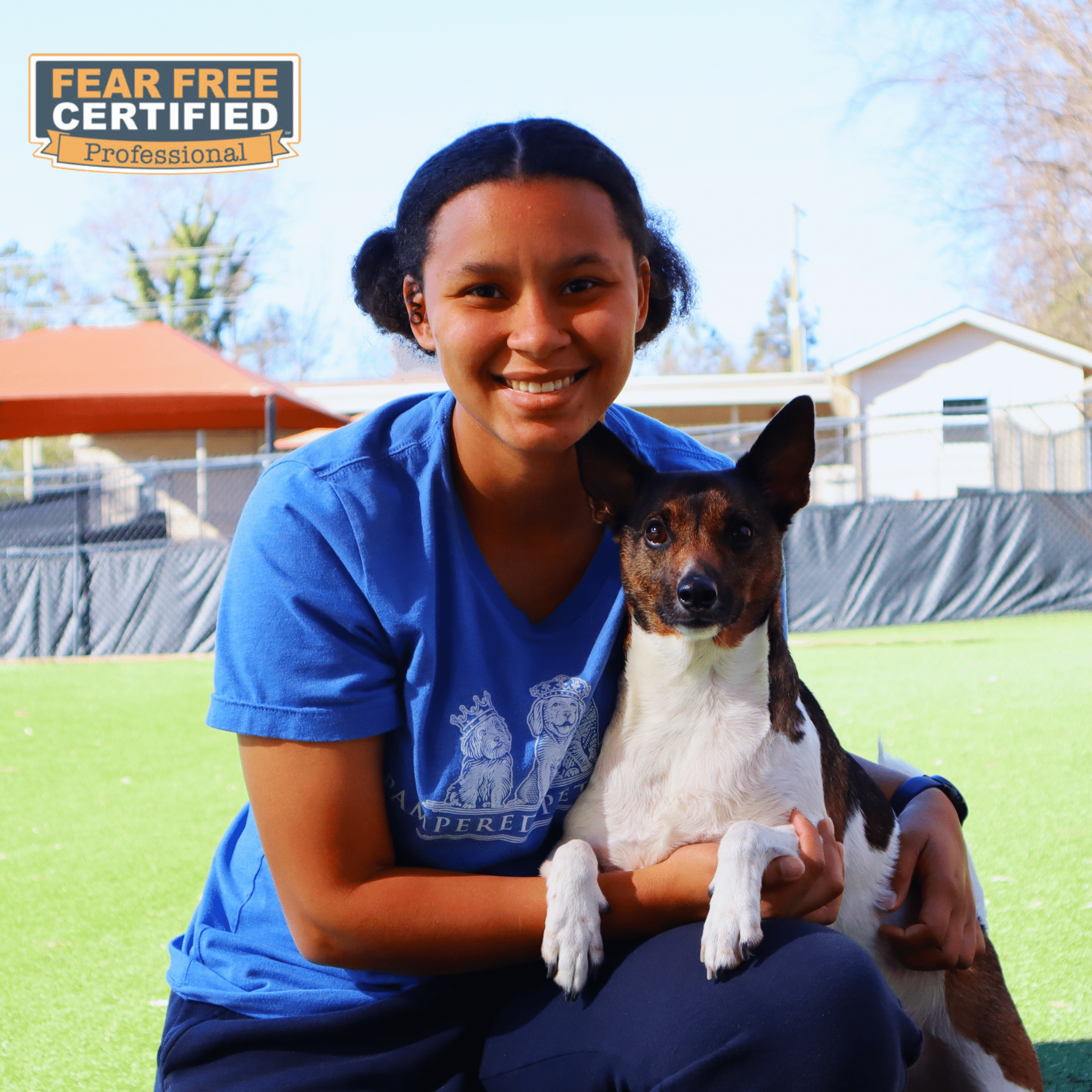 Staff member posing with dog guest