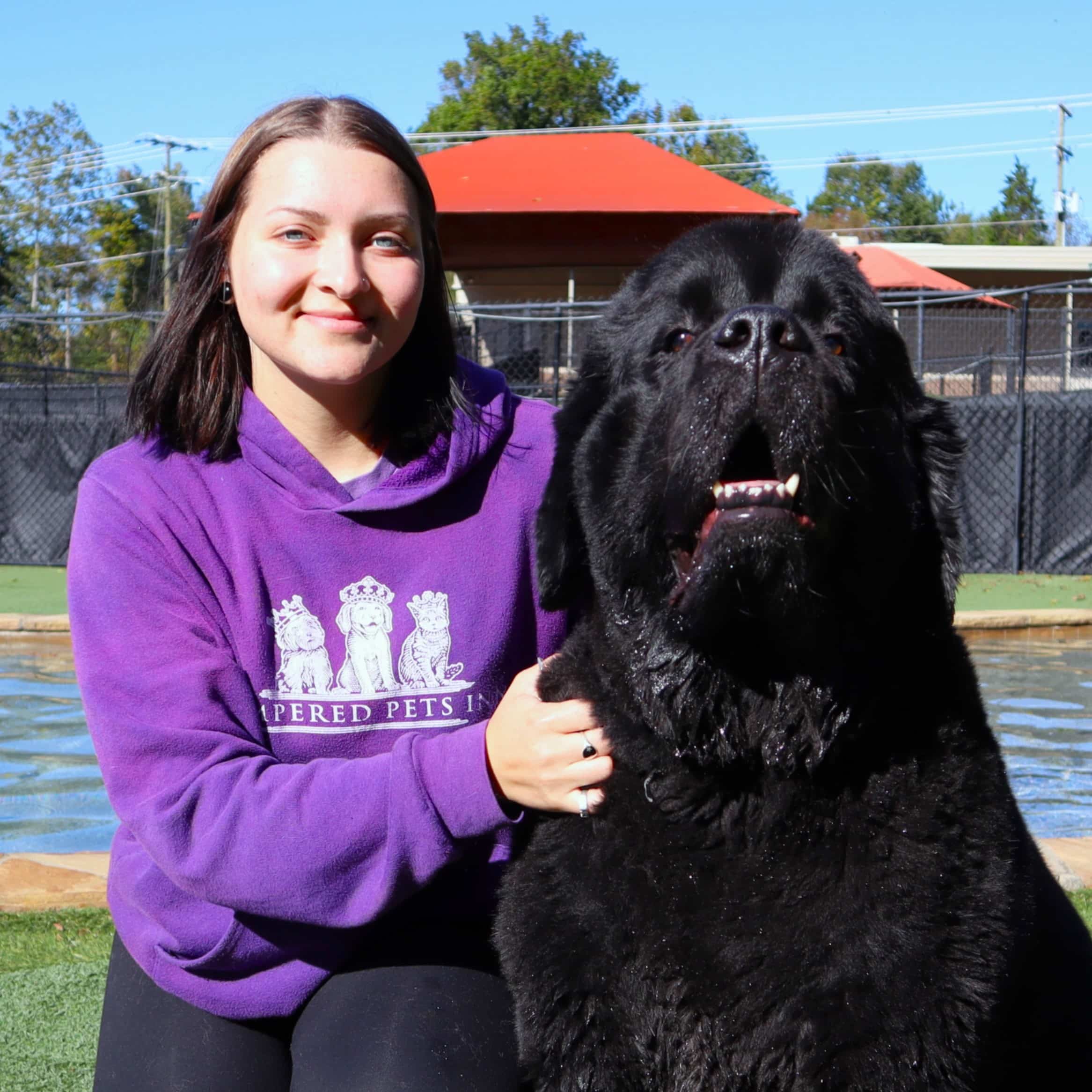 Staff member posing with dog guest